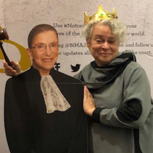 Photo of Janet Rubien posing with cardboard cutout of Ruth Bader Ginsburg