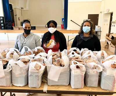 3 women wearing masks organizing donations