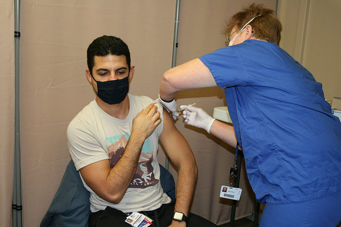 Man receiving a vaccination in a hospital