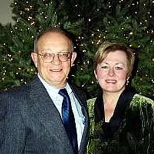 Divo Messori with a woman in front of a Christmas tree